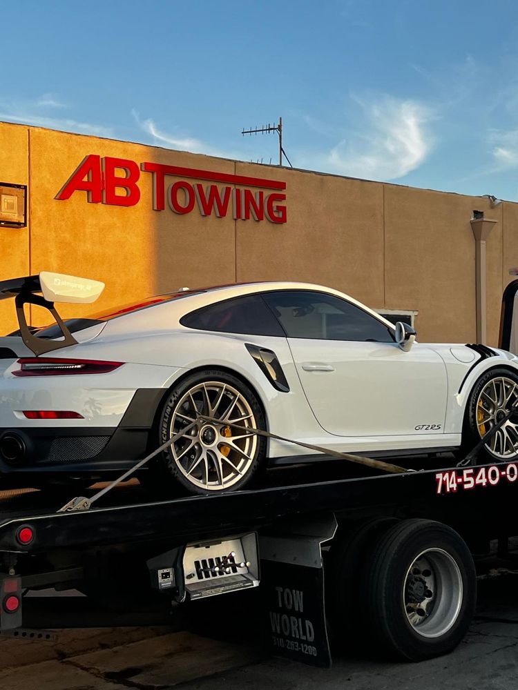 A&B Towing professional flatbed transporting a luxury vehicle